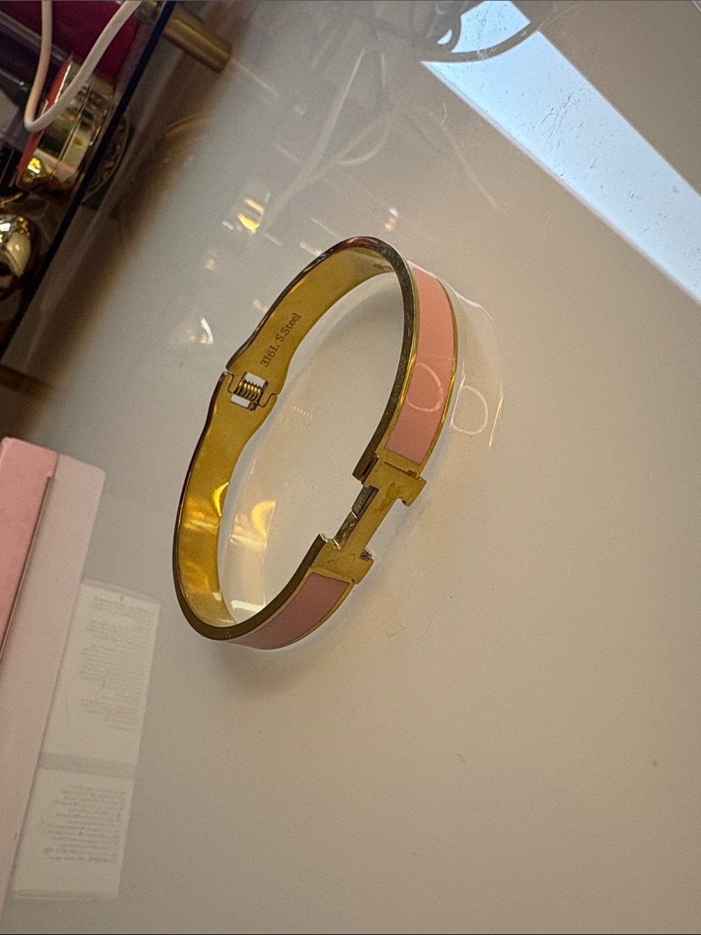 Light pink and gold clic clac Hermes bracelet
